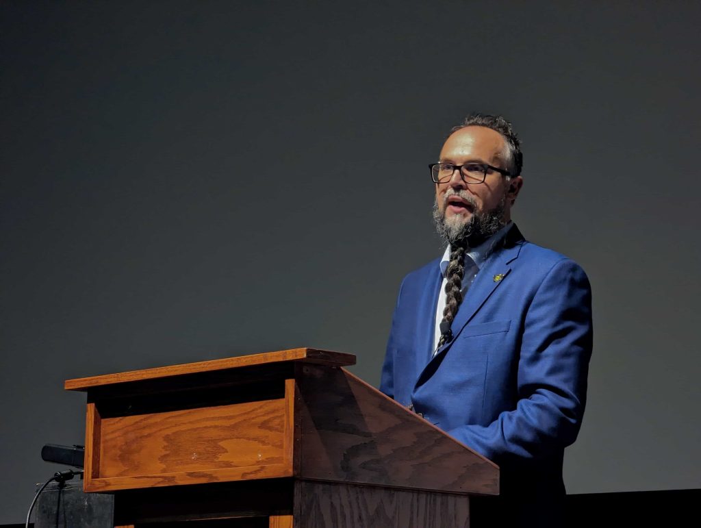 Dr. Kyle Powys Whyte speaking to the crowd during his lecture on November 6, 2023.