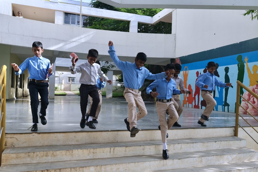 Shanti Bhavan students happily running through the school grounds.